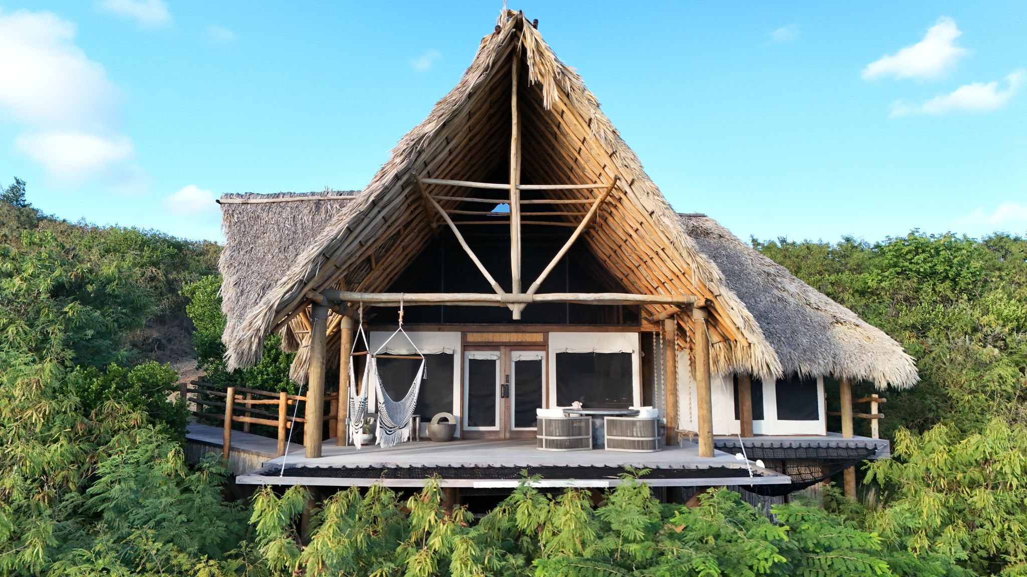 image Marvel at the architectural beauty of Abundance, designed to harmonize with its lush surroundings, inviting you to unwind and rejuvenate on your island escape.
