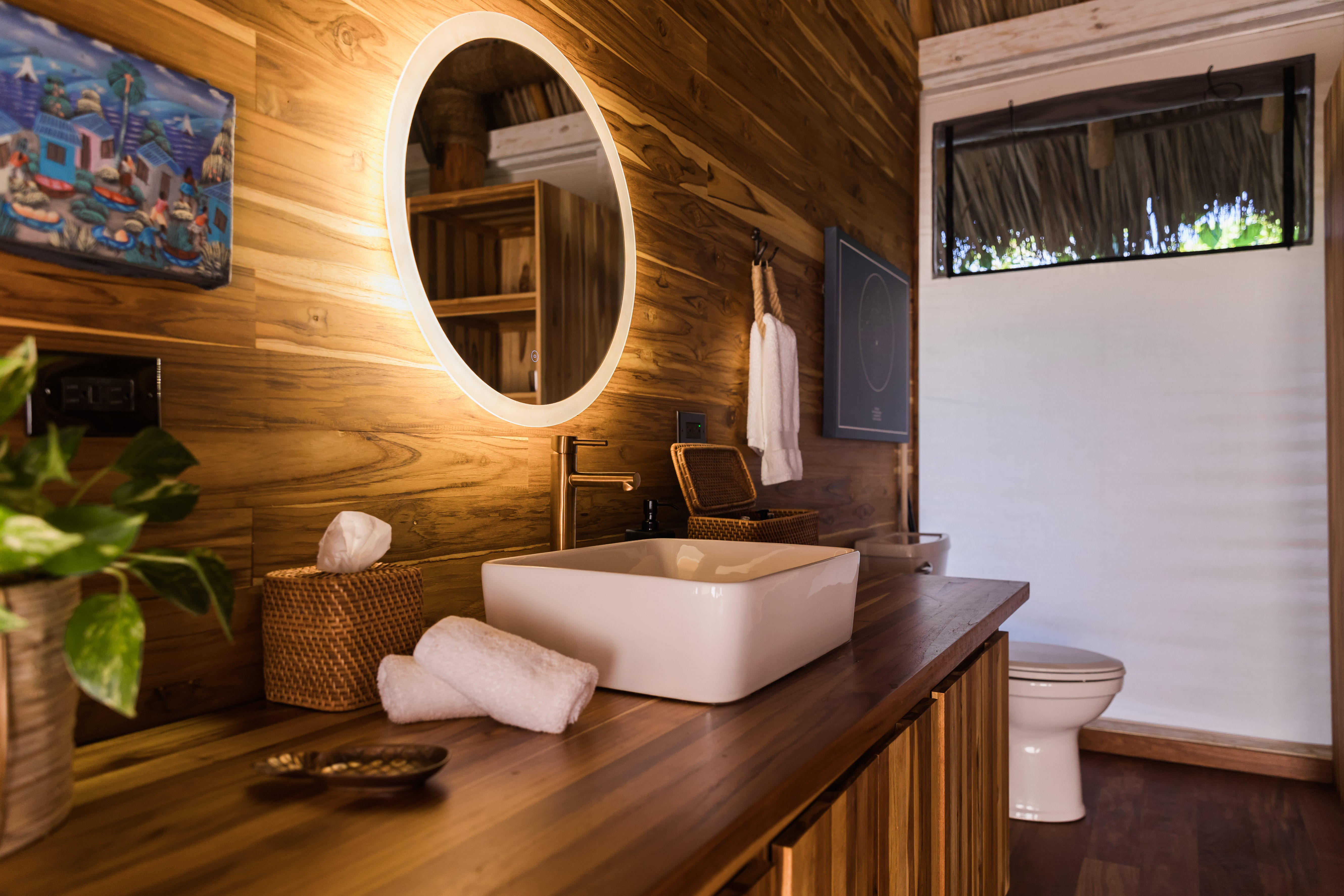 image Spa-inspired bathroom with natural wood finishes, soft lighting, and a modern vessel sink.