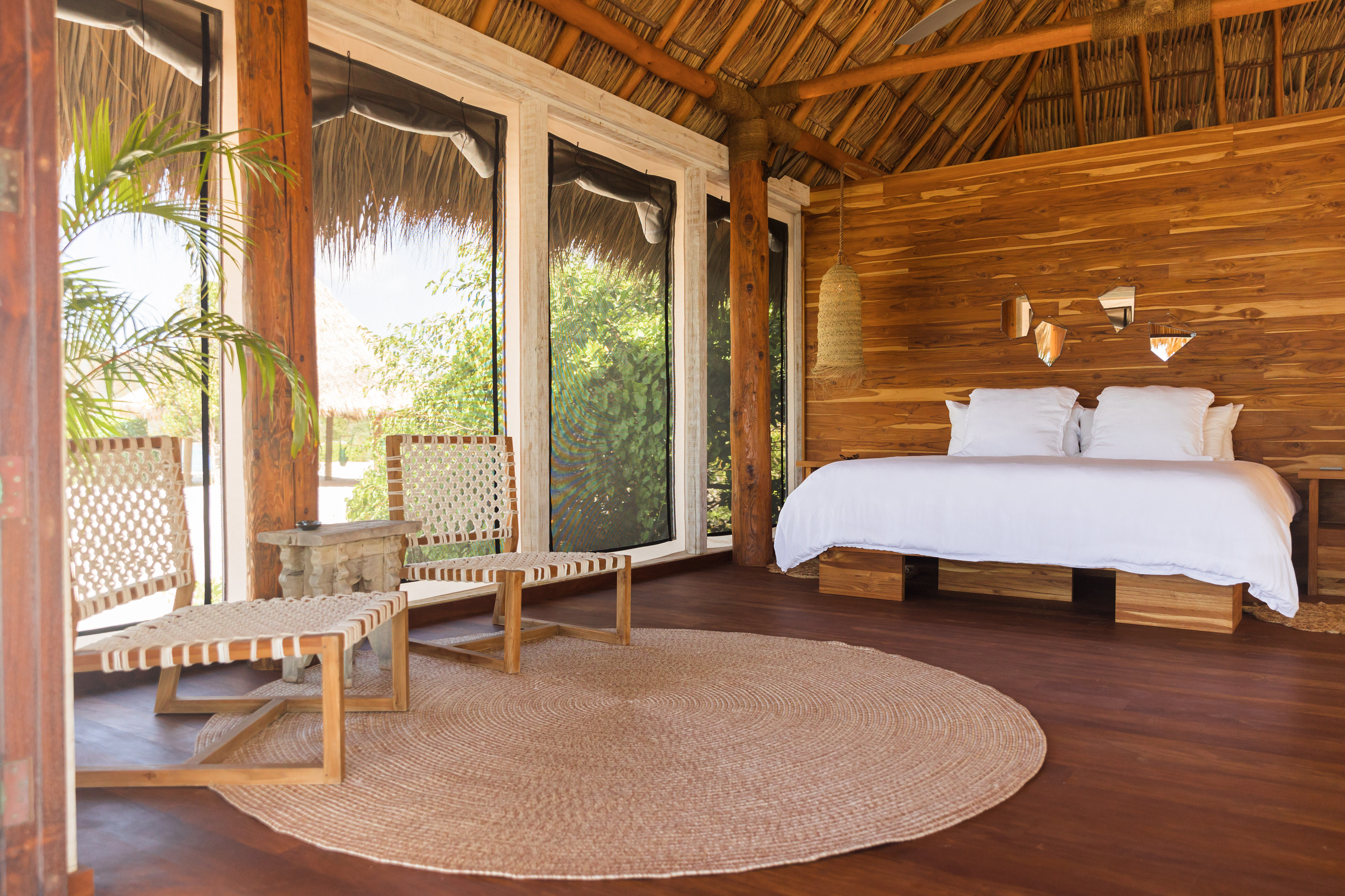 image Bright and airy bedroom with island-inspired decor and seamless indoor-outdoor flow.