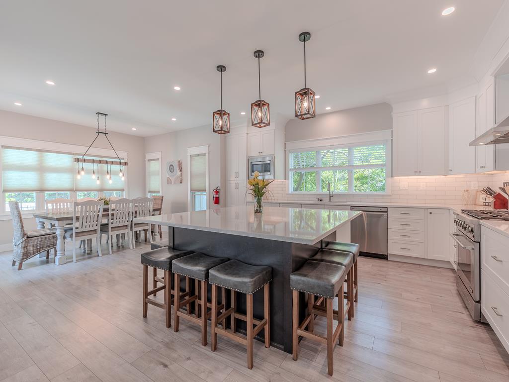 image Chef’s kitchen with a massive center island, stainless steel appliances, and plenty of seating—great for entertaining or family meals.