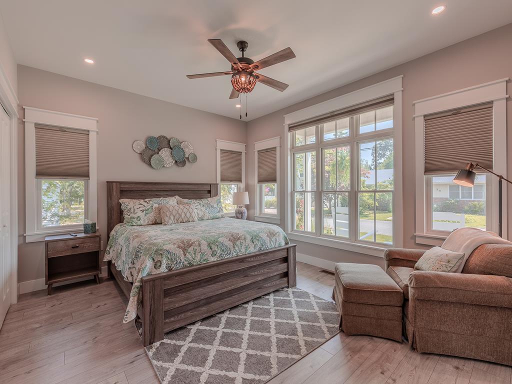 image First-floor master bedroom with king bed, cozy seating area, and direct access to the backyard deck.