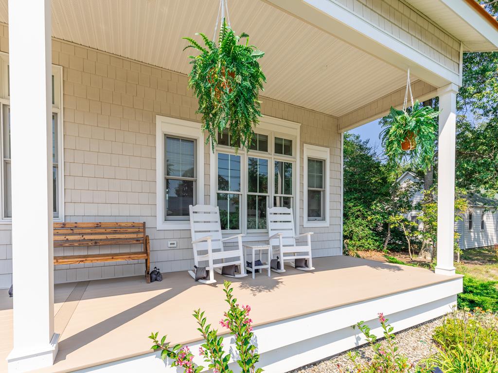 image Covered front porch with rockers and a bench—ideal for sipping your morning coffee or enjoying the coastal breeze.