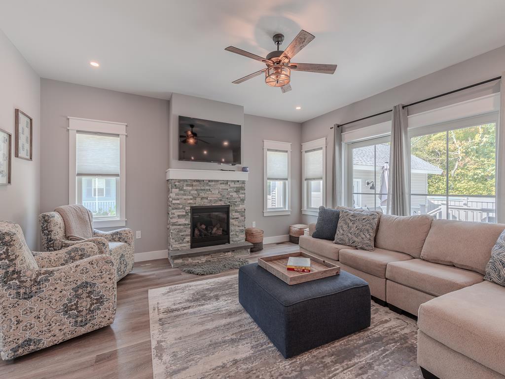 image Cozy living room with plush seating and a fireplace—perfect for family movie nights or cool fall evenings.
