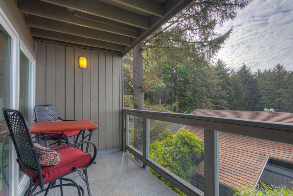 image The forest-view patio invites you to unwind with a small table and chairs, surrounded by serene greenery for a peaceful retreat.
