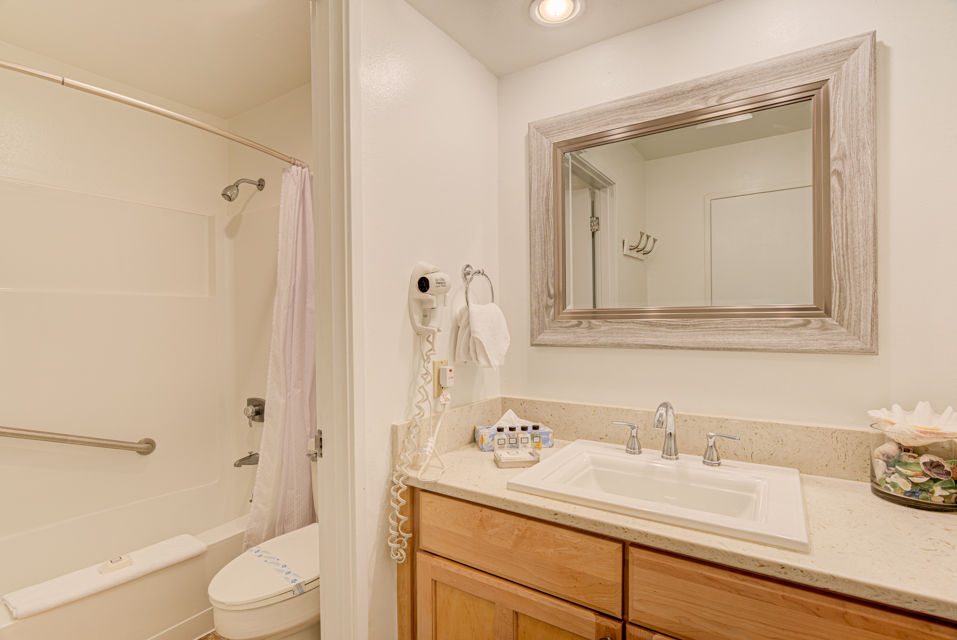 image Relax in the well-appointed bathroom, ensuring a comfortable stay during your oceanfront retreat.