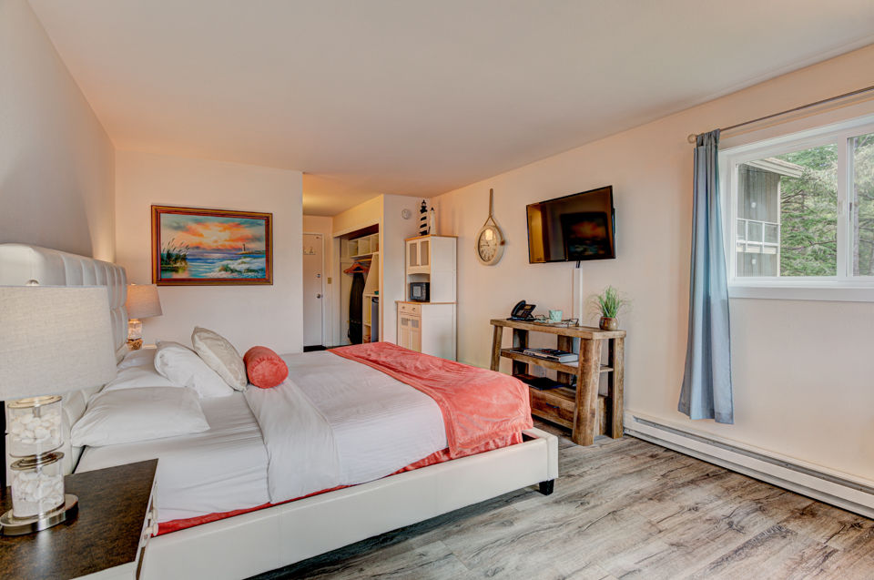 image The inviting bedroom features warm coastal décor and a comfortable king bed for a restful stay.
