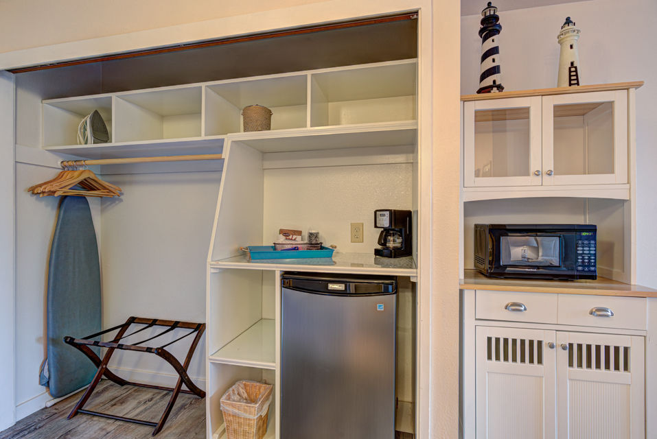 image Enjoy the convenience of a well-equipped kitchenette with microwave, coffee maker, and mini fridge.