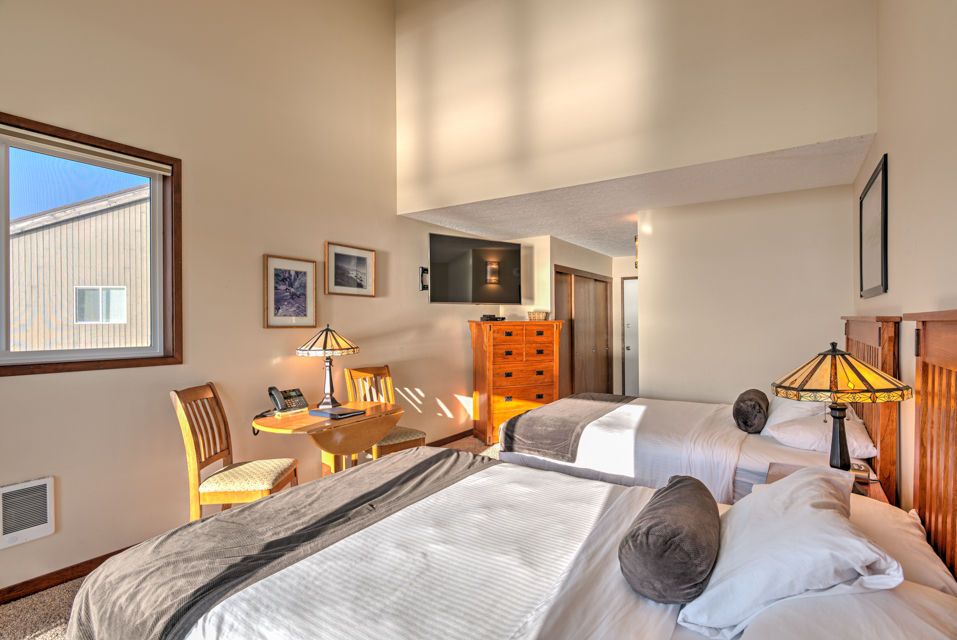 image The spacious 2 Queen Bedroom showcases two inviting queen beds, a comfortable sitting area, and ample natural light, complemented by a well-appointed kitchenette.