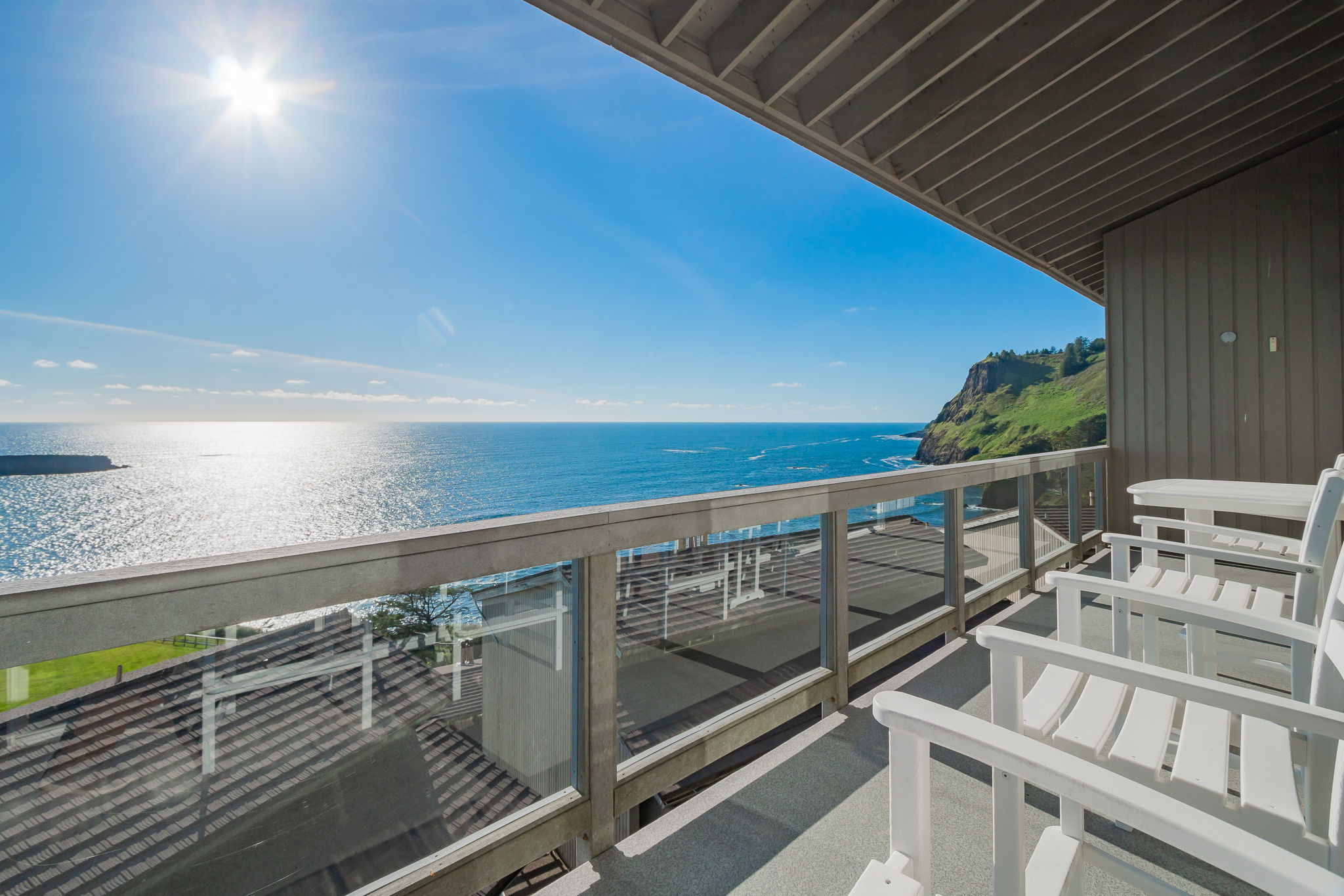 image Private balcony with seating and panoramic ocean views stretching along the rugged Oregon coastline.