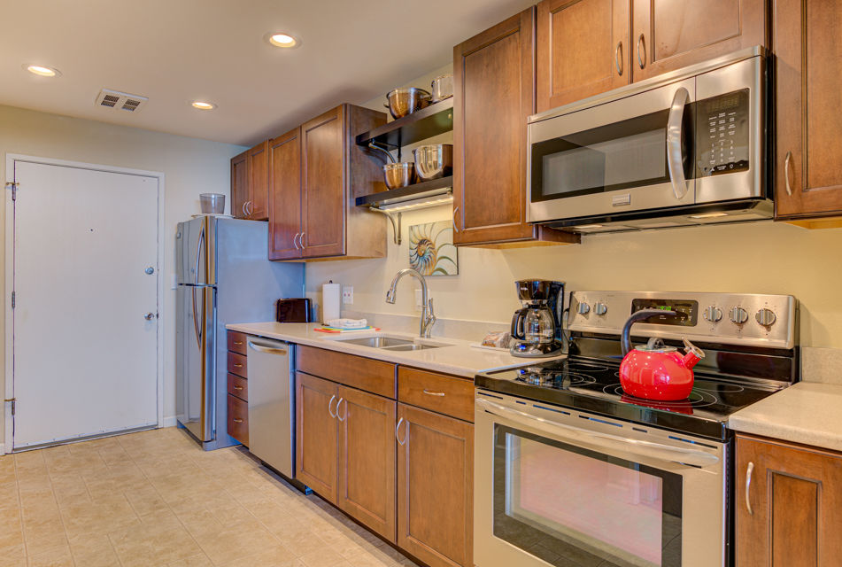 image Equipped with stainless steel appliances and stylish cabinetry, the full kitchen offers everything you need to prepare meals during your beach getaway.