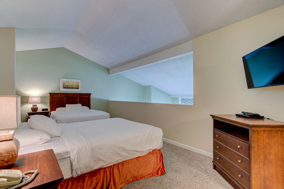 image The upper level of the loft provides an inviting atmosphere with additional sleeping space, highlighted by its light-filled design and cozy furnishings.