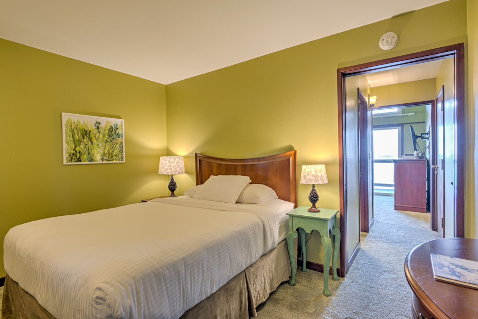 image The cozy bedroom is highlighted by a comfortable queen bed, complemented by warm tones and soft lighting for a restful retreat.