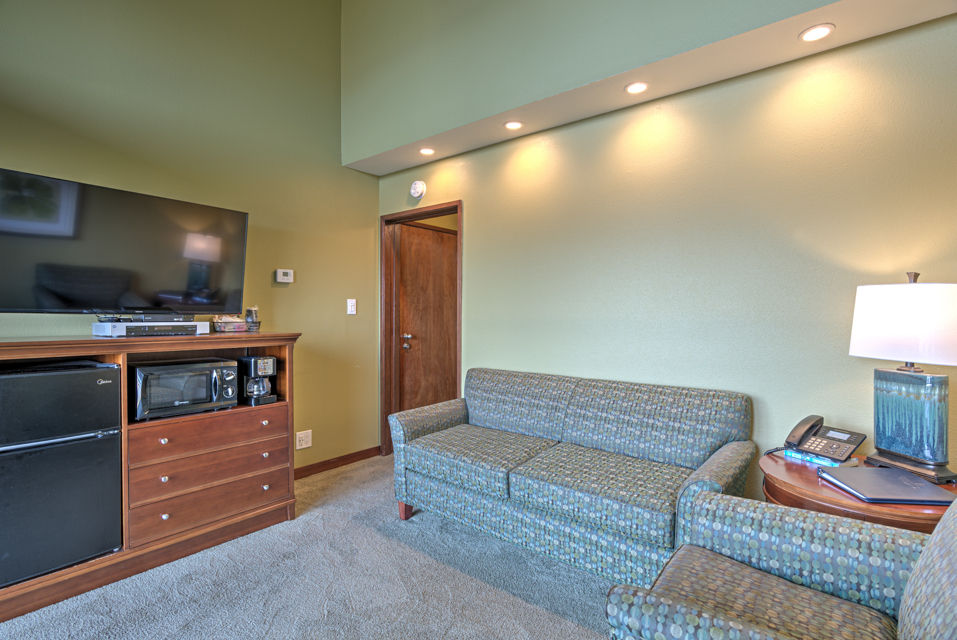 image The kitchenette area is neatly arranged and equipped with modern appliances, perfect for preparing light meals while enjoying the ambiance of the ocean view.