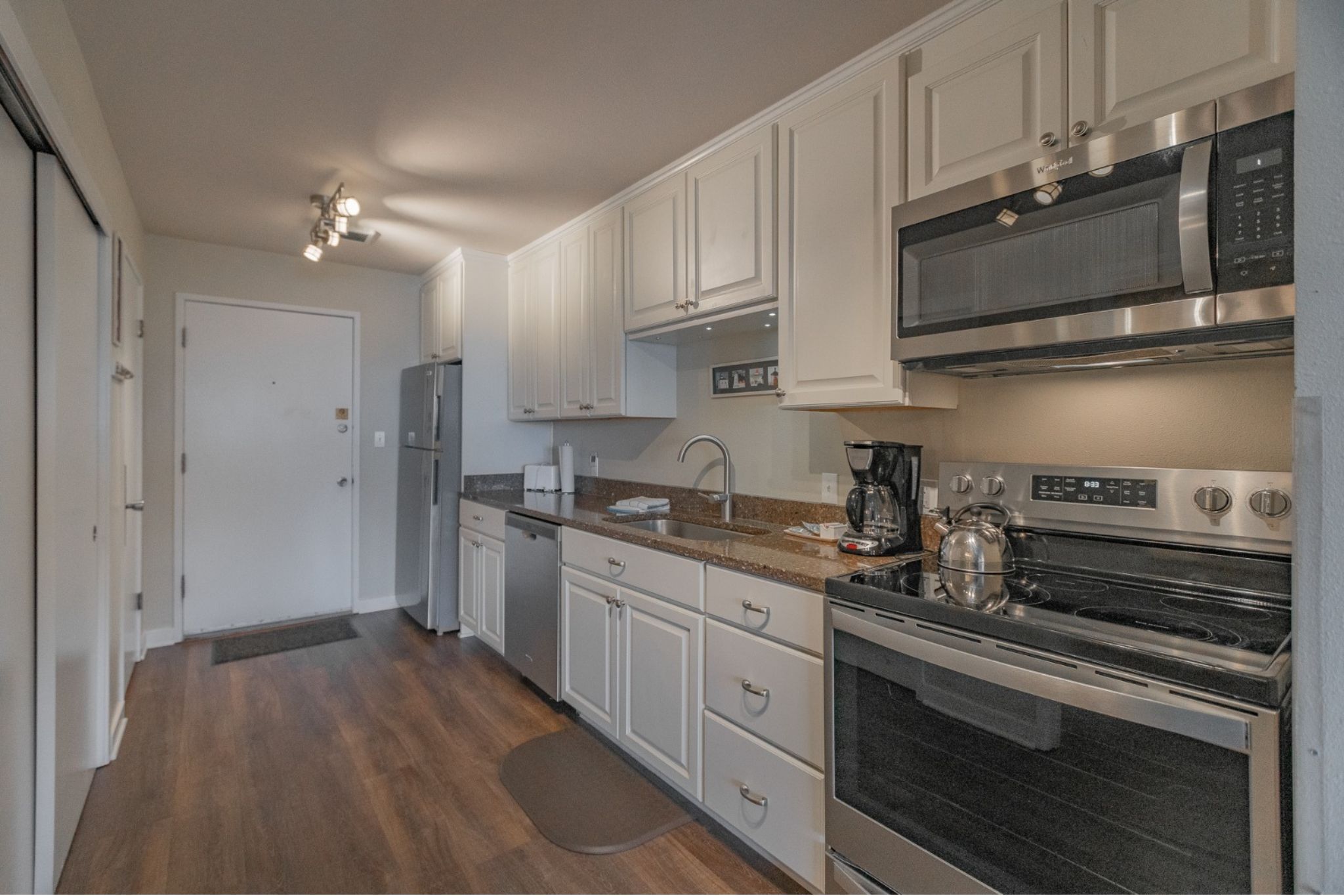 image The sleek full kitchen is equipped with modern appliances, providing everything you need for cooking and dining.
