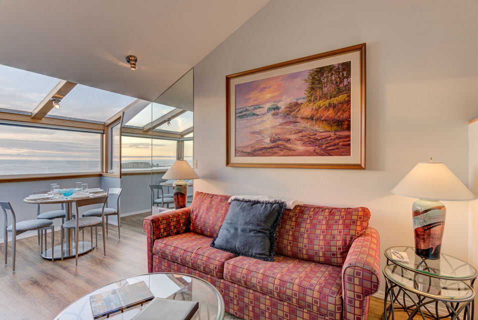 image Bathed in natural light, the sitting and dining areas offer a delightful ocean view.