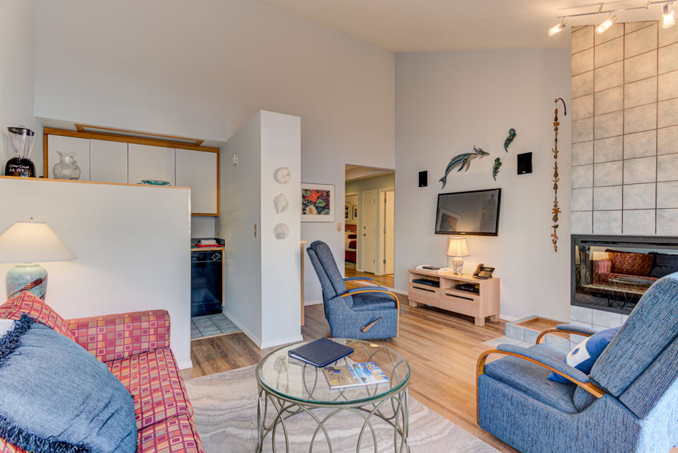 image The living area includes a comfortable seating, creating a welcoming space for relaxation, with a kitchenette conveniently nearby.