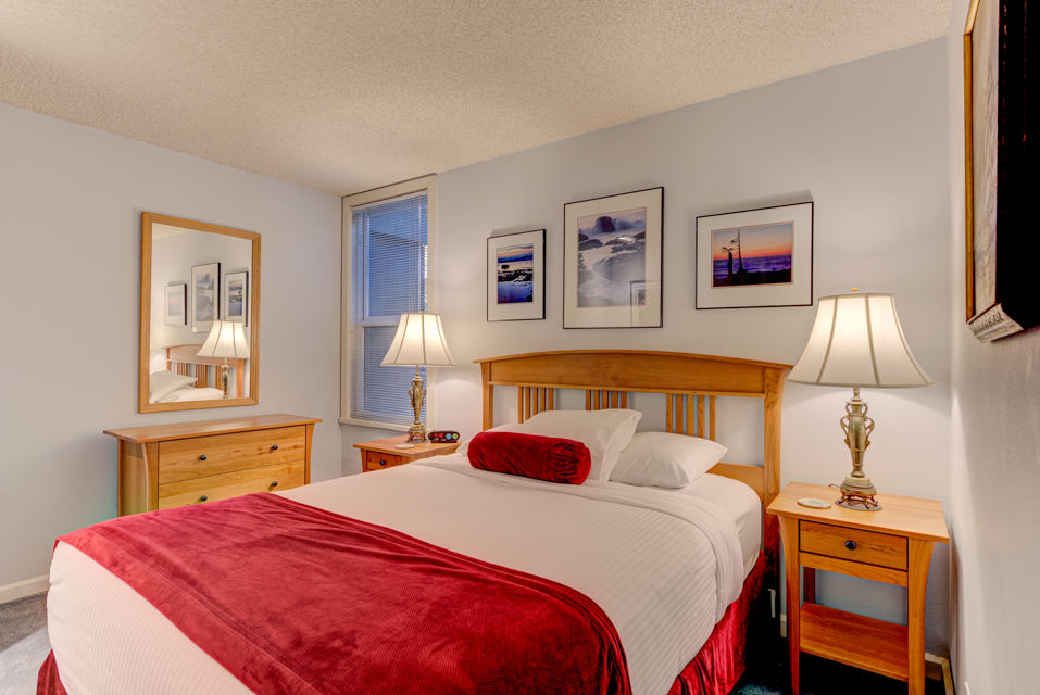 image This cozy studio features a queen bed adorned with plush pillows and bedside tables, offering a serene atmosphere enhanced by tasteful artwork.