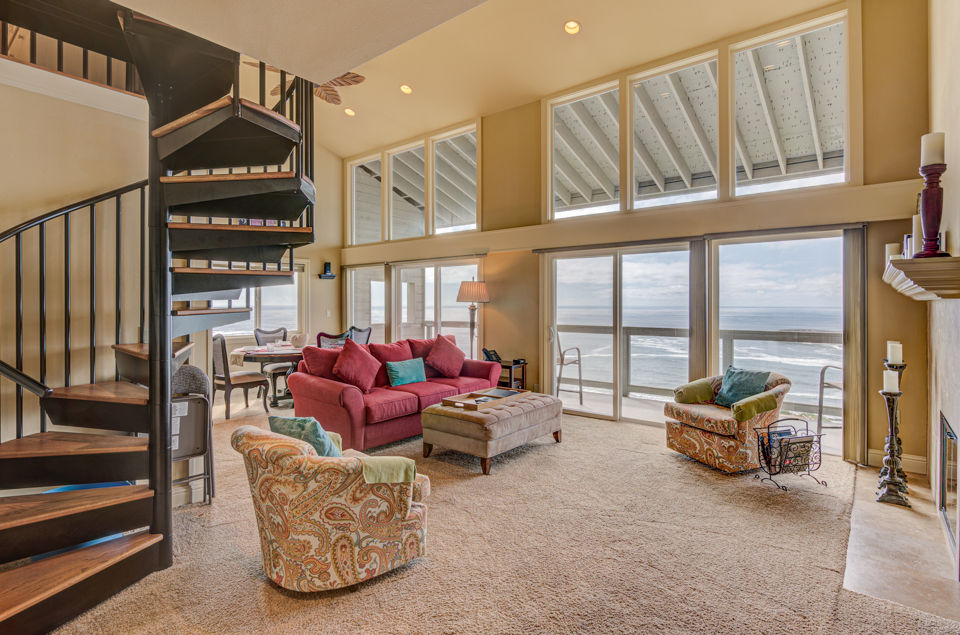 image Experience breathtaking panoramic ocean views from the spacious living room, complete with a dining area and a balcony, all adjoining a fully equipped kitchen.
