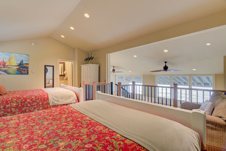 image The loft area contains two queen beds and offers a unique vantage point, perfect for enjoying ocean views, with easy access to the adjacent bathroom.