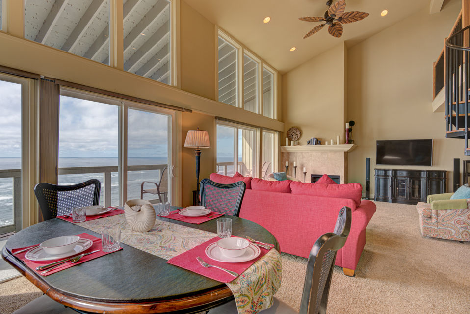 image Dine in style with stunning ocean vistas in the dining area, easily accessible from the inviting living room that features plush seating and a warm atmosphere.