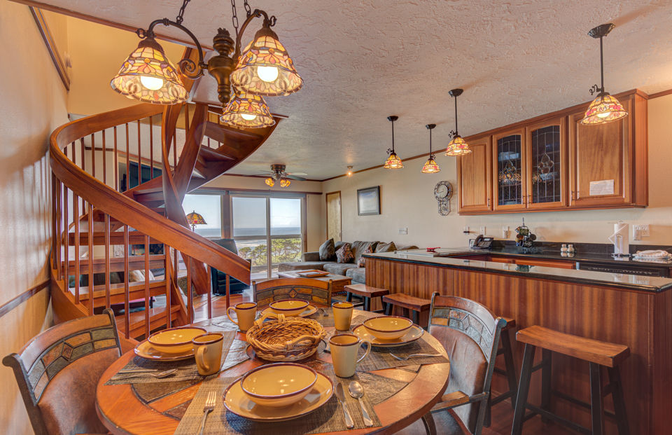 image The dining area is inviting and perfect for family meals, featuring an elegant table set for gatherings and beautiful views of the ocean.