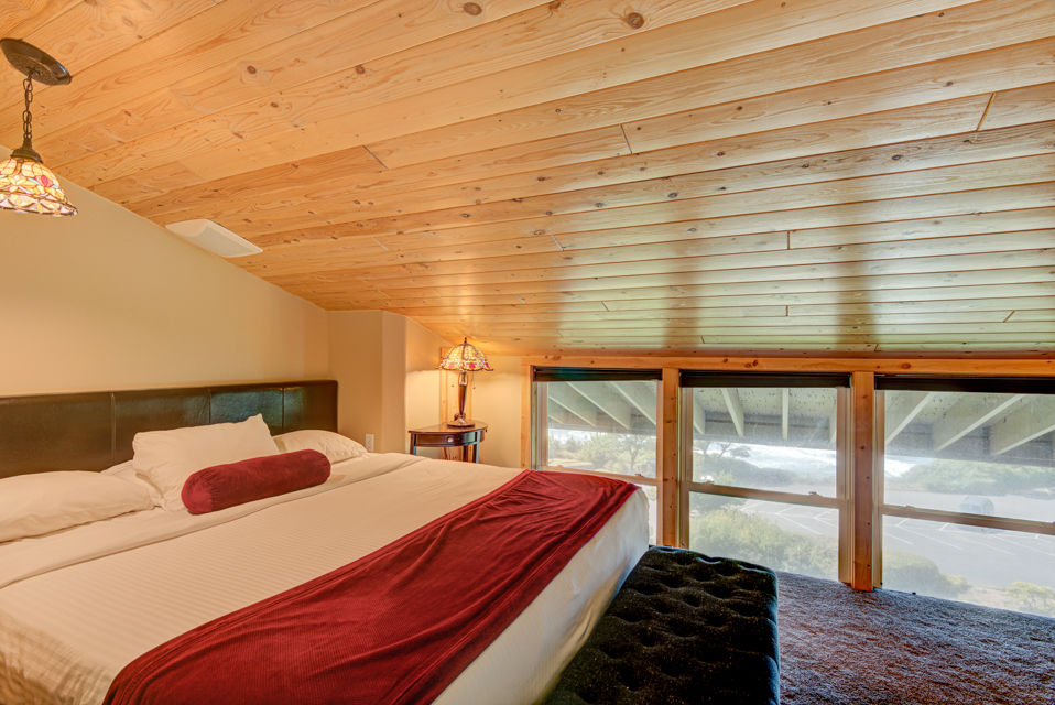 image The king bedroom offers comfort and charming decor, designed to ensure a restful night's sleep while enjoying the unique architecture of the suite.