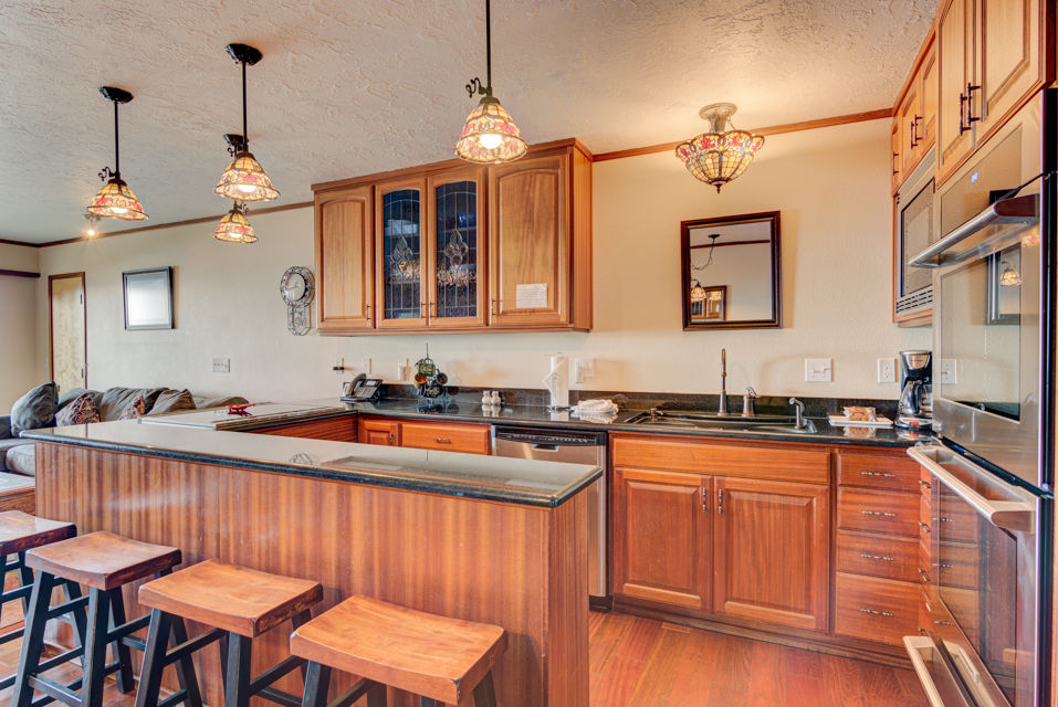 image The gourmet kitchen boasts polished wooden cabinetry and ample countertop space, perfectly designed for family gatherings and culinary delights.