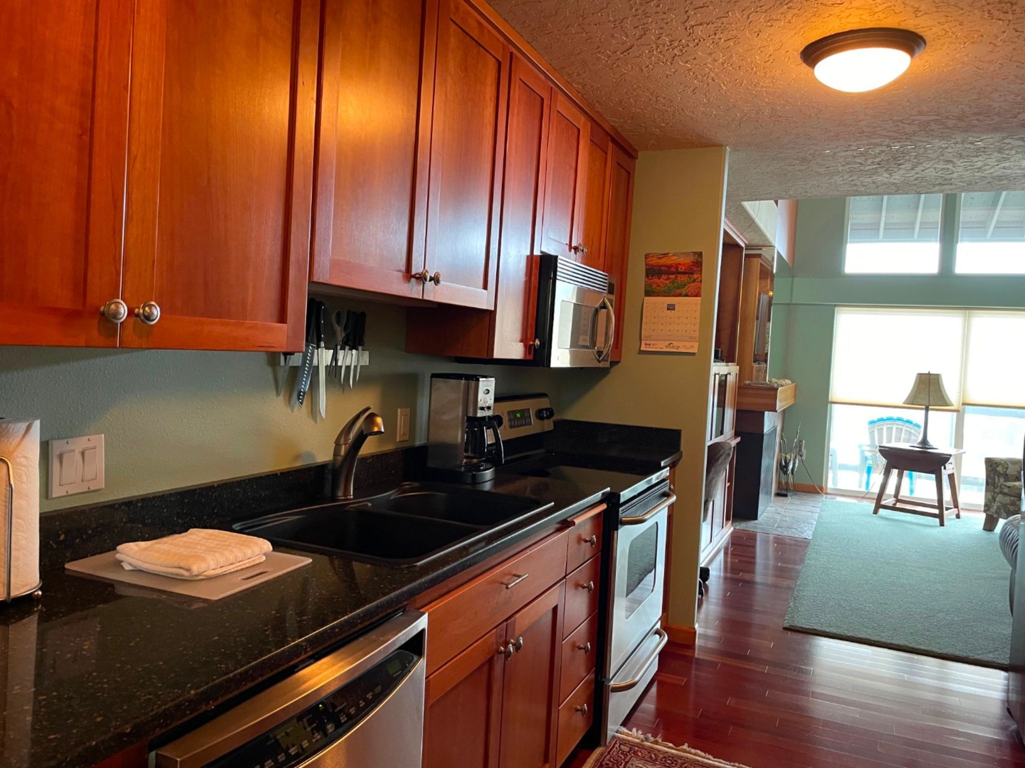 image This well-equipped full kitchen boasts sleek cabinetry, modern appliances, and ample counter space, perfect for preparing delicious meals.