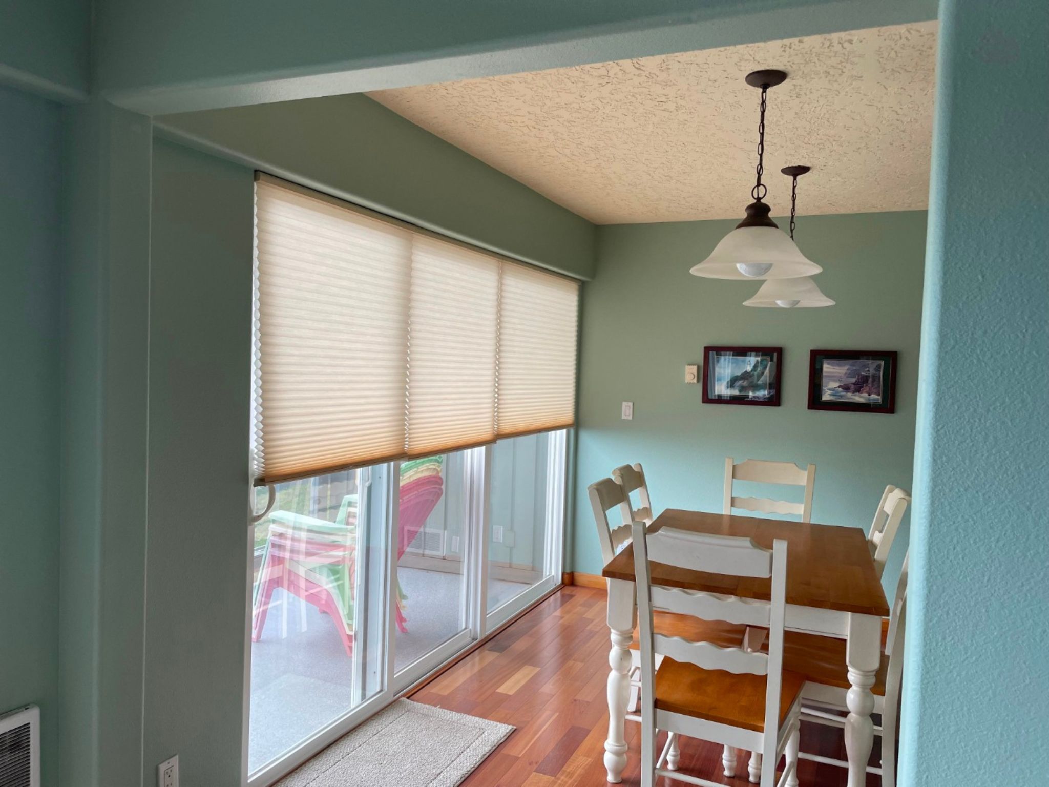 image The inviting dining area, with its bright decor and large windows, offers a delightful space for family meals while enjoying ocean views.
