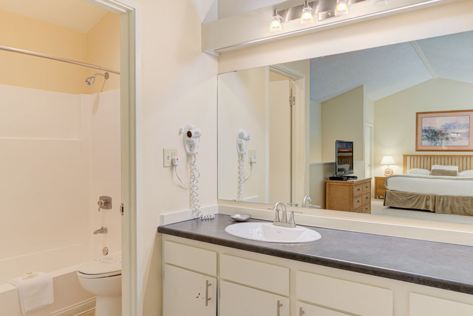 image The well-appointed bathroom features a sleek design, complete with essential amenities and a view leading back into the living space.