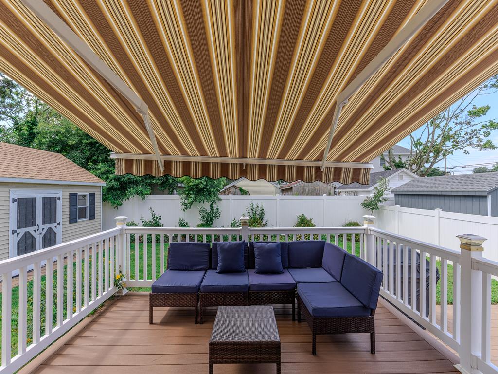 image Covered outdoor seating area with a retractable awning—ideal for staying cool while enjoying sunny days.