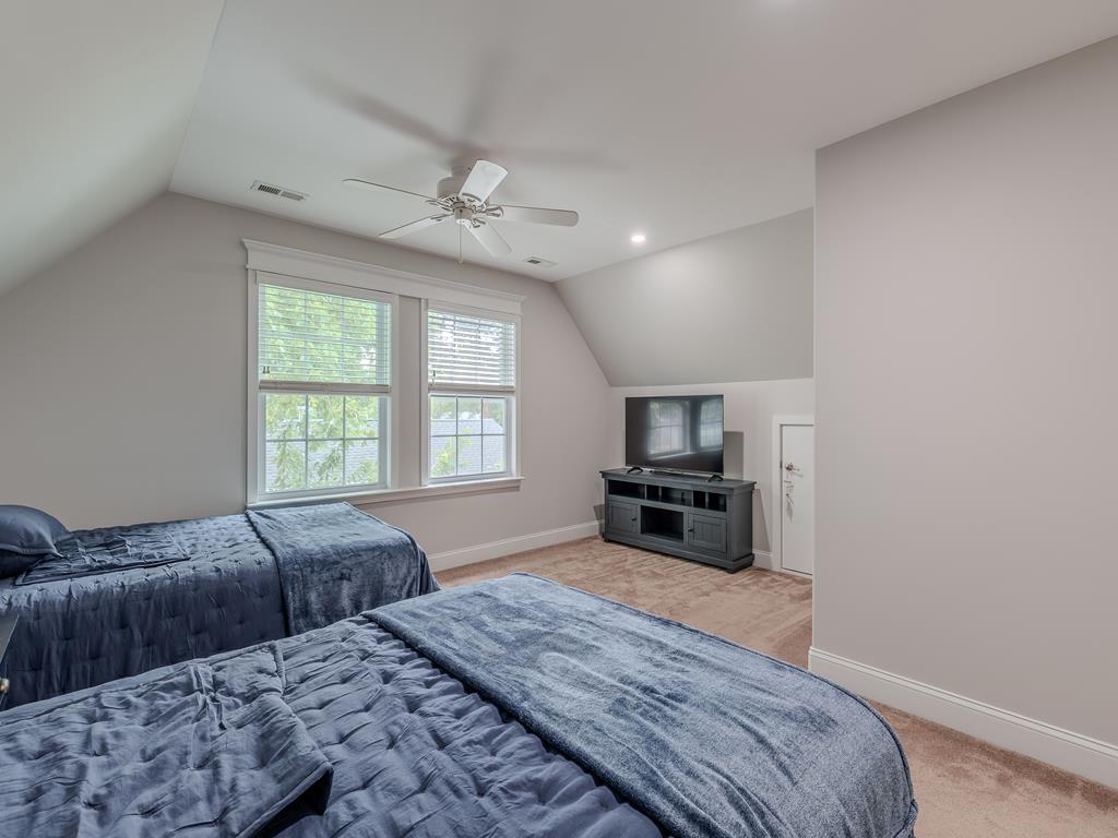 image Upstairs space doubles as a bonus hangout area with twin beds and entertainment setup for cozy evenings in.