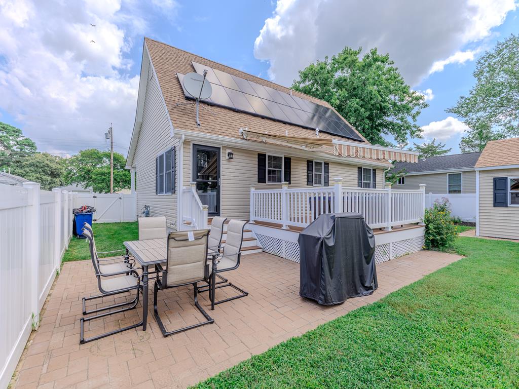 image Backyard patio with BBQ grill and dining area—great for al fresco meals and gatherings.