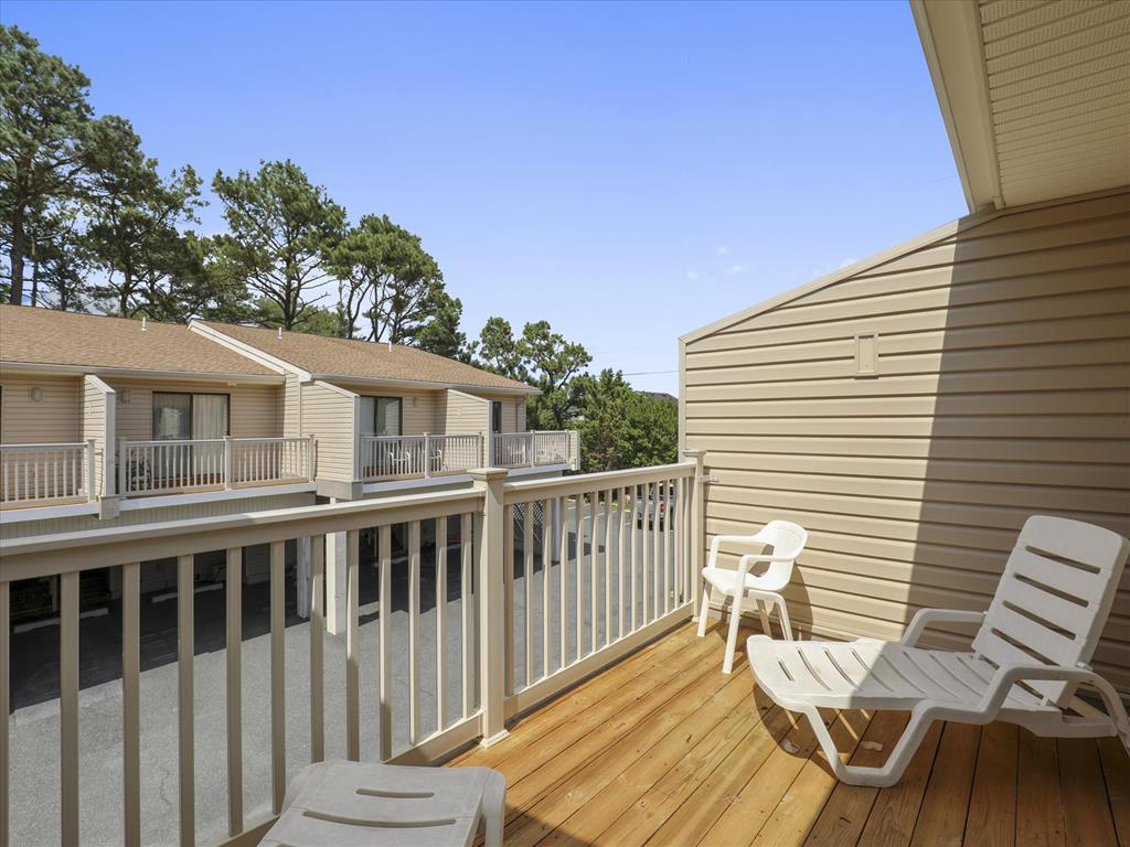 image Relax on the private deck, soaking in the sun while enjoying the company of friends on comfy lounge chairs.