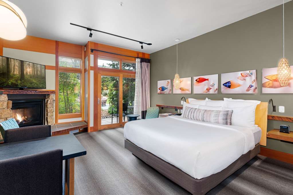 image Spacious retreat with warm wood tones and a glowing fireplace sets the stage for restful nights.