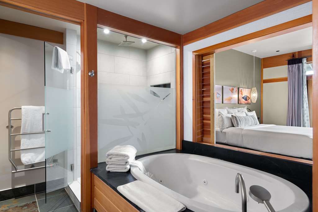 image Jetted soaking tub and rain shower offer a spa-like sanctuary designed for complete relaxation.