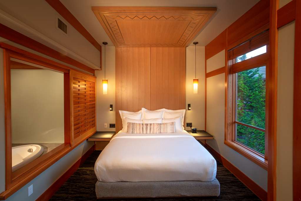image Plush bed framed by soft lighting creates a serene place to rest and recharge.