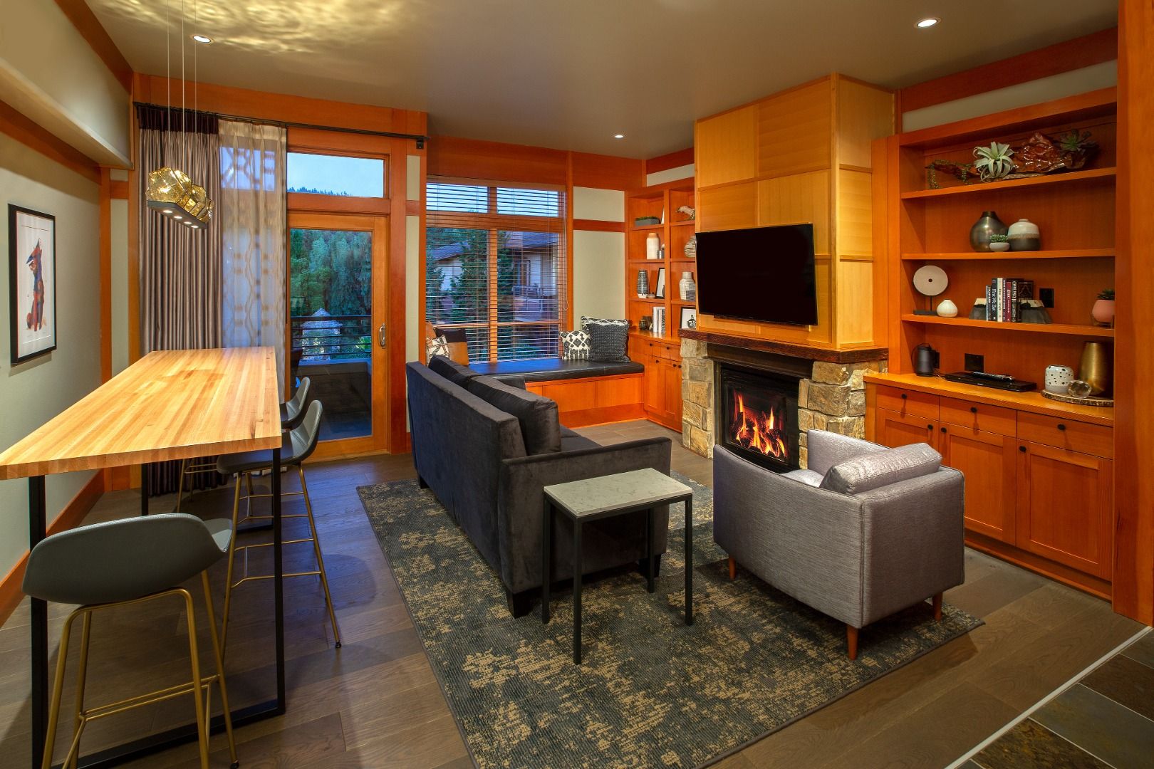 image Warm wood floors and a stone fireplace set the tone for a retreat rich in rustic elegance.