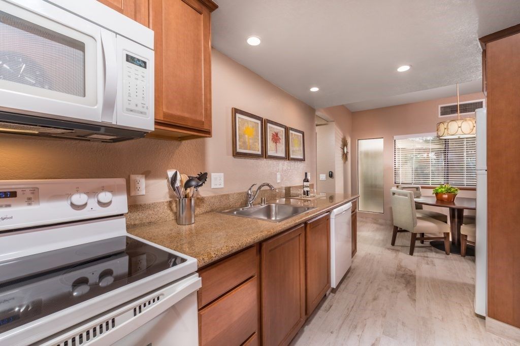 image This fully-equipped kitchen boasts sleek appliances and ample counter space, perfect for culinary adventures while enjoying casual dining nearby.
