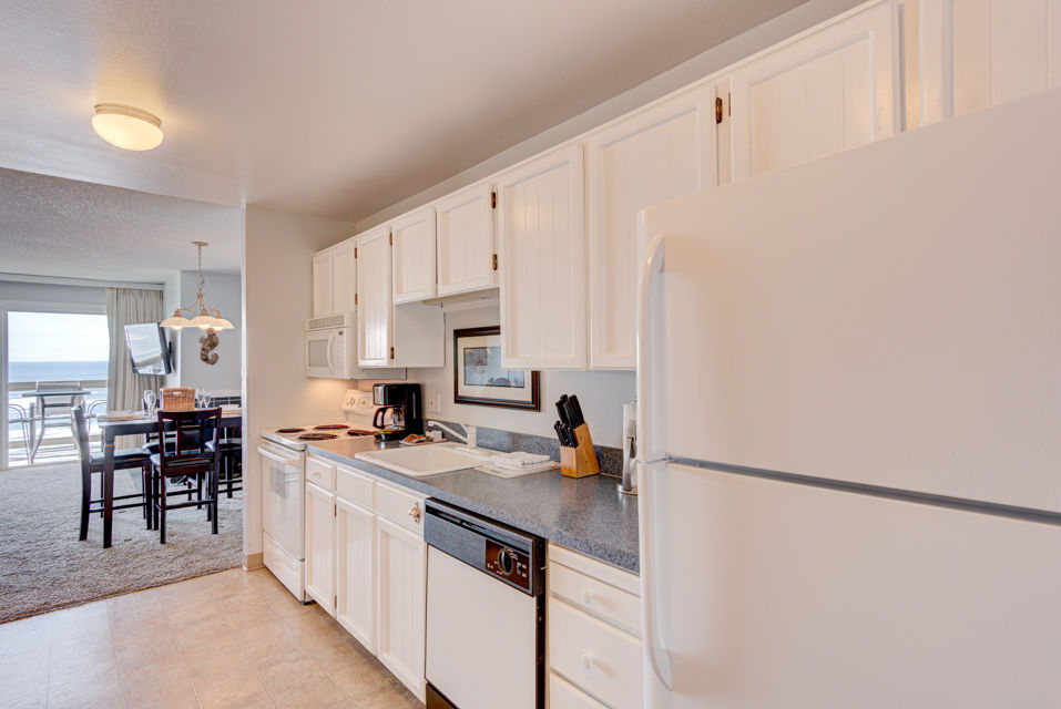 image The modern kitchen boasts ample storage and counter space, perfect for preparing meals while enjoying the stunning ocean views from this Panoramic Ocean View King Bed Studio.