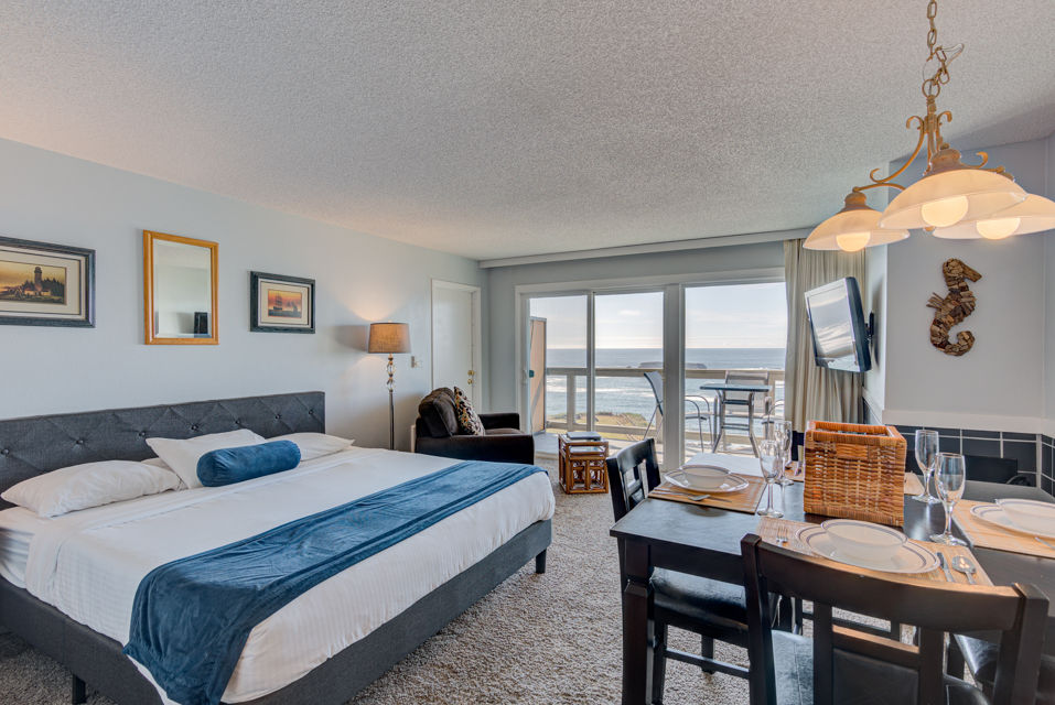 image Experience breathtaking panoramic ocean views from this spacious studio featuring a luxurious king bed, a cozy kitchen, and a private patio for ultimate relaxation.