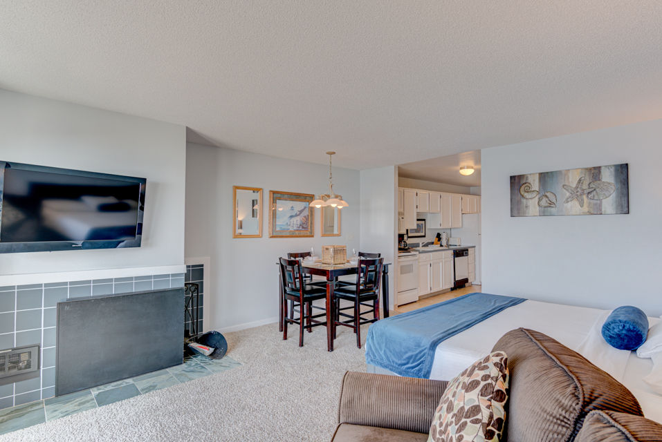 image The inviting king bed and stylish seating area complement the panoramic ocean views visible through large windows in this comfortable studio, complete with a well-equipped kitchen.