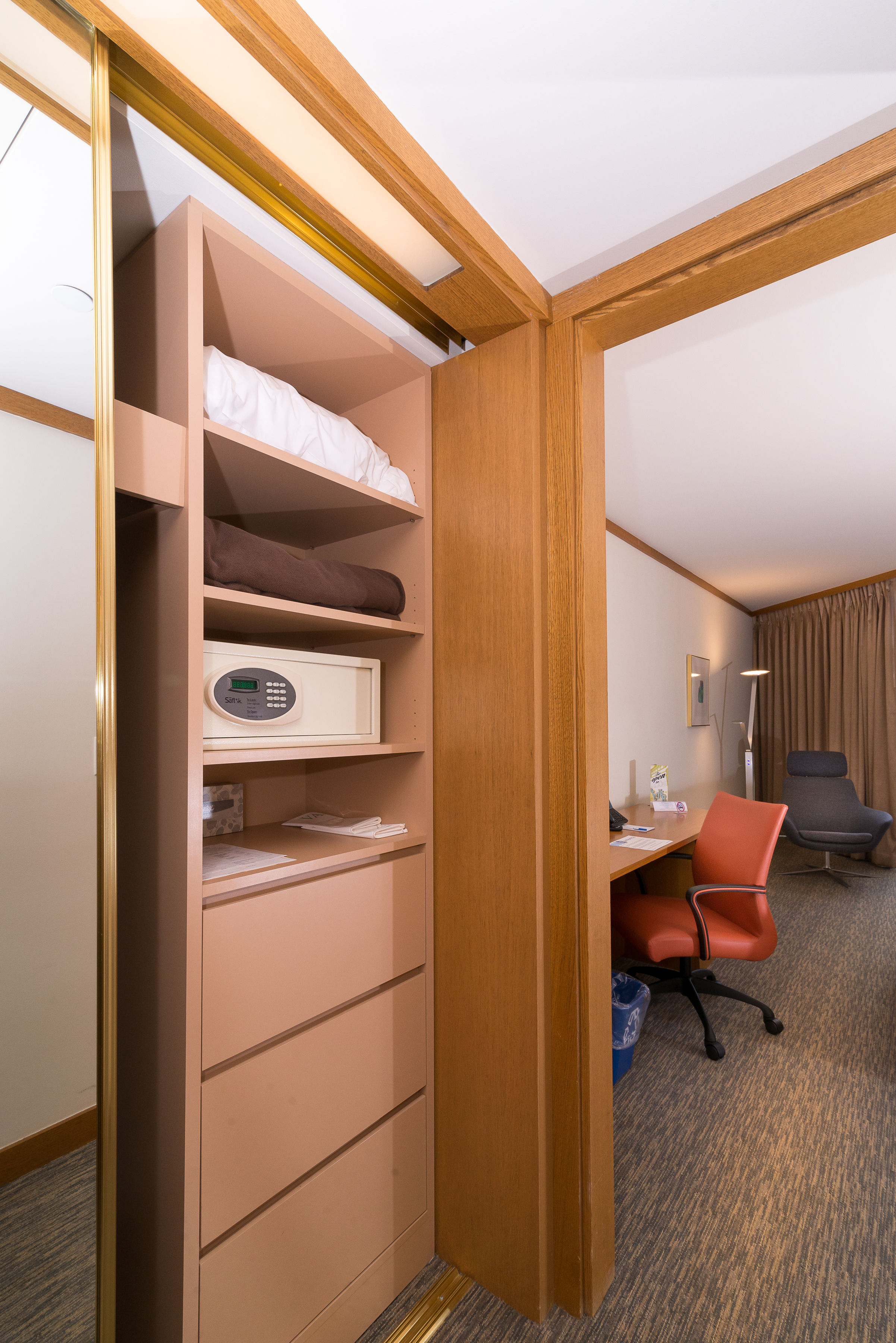 image Discover ample storage solutions in the cleverly designed closet area, equipped with shelving, a safe, and easy access to your essentials while enjoying your stay.
