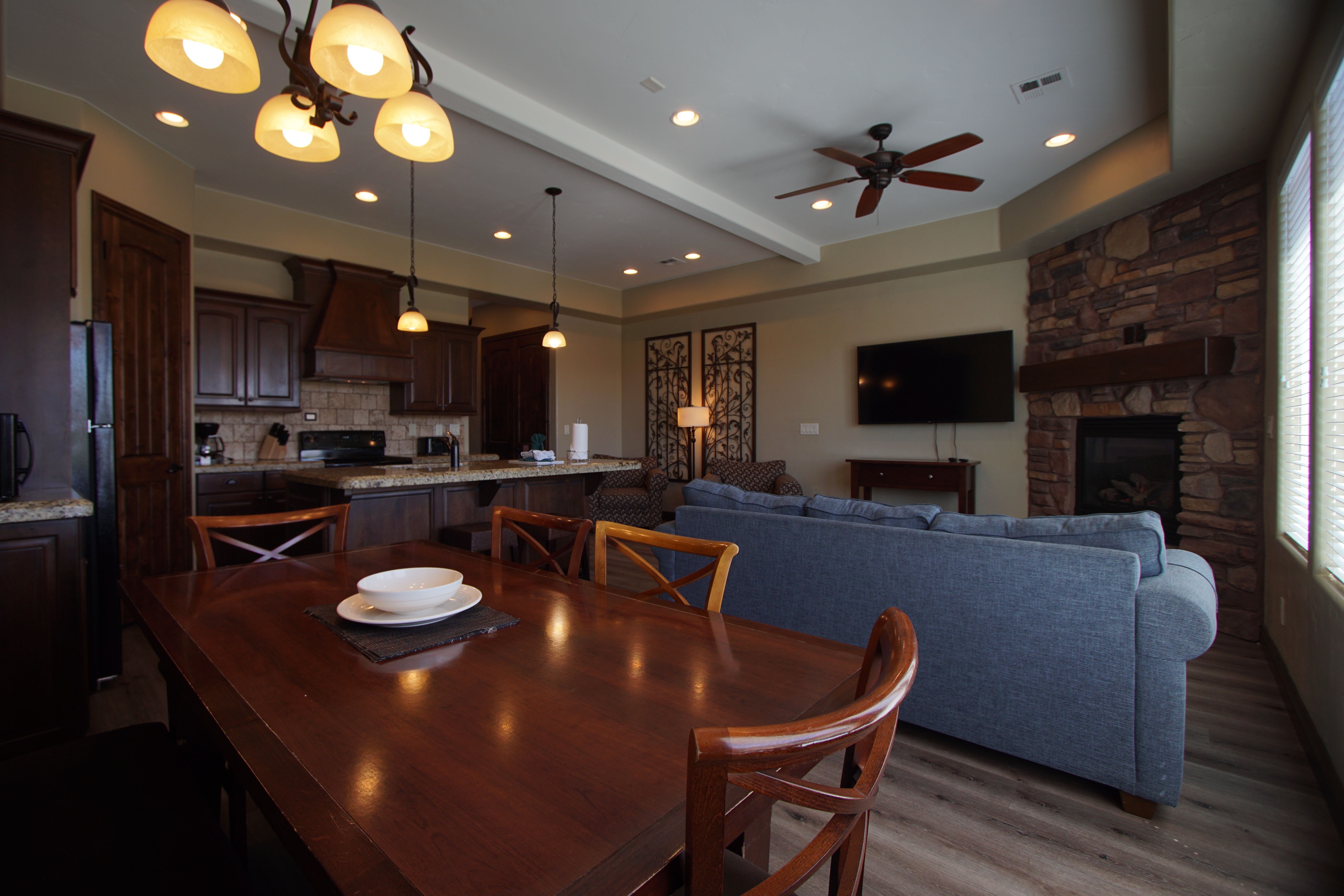 image Open-concept living and dining area with fireplace and comfortable seating.