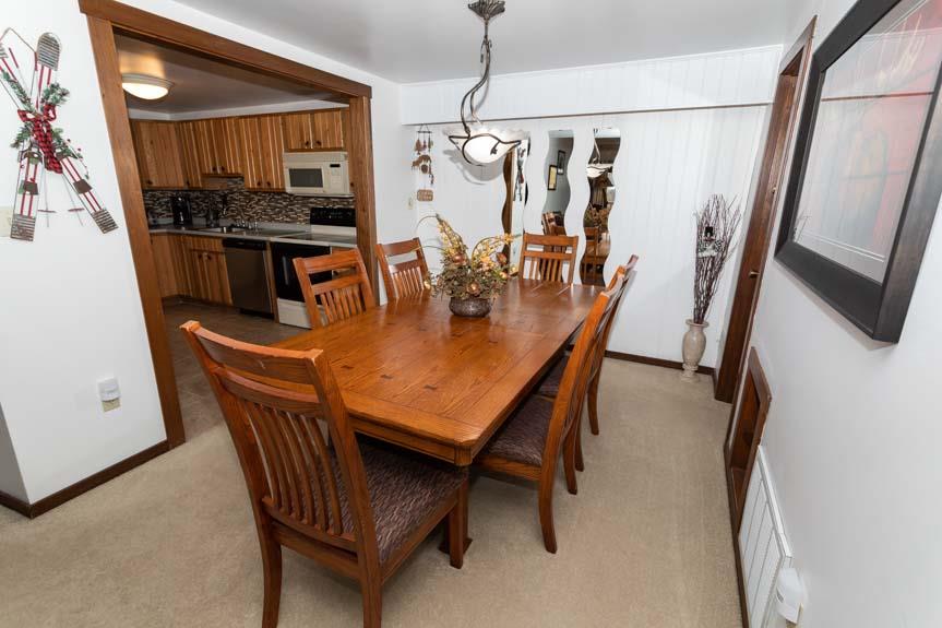 image Gather around the elegant dining table, complemented by warm wood tones and inviting decor, ideal for family meals.