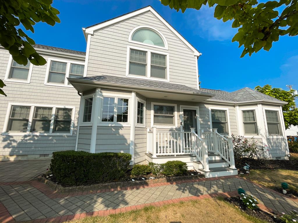 image Inviting front porch welcomes you steps from the beach.