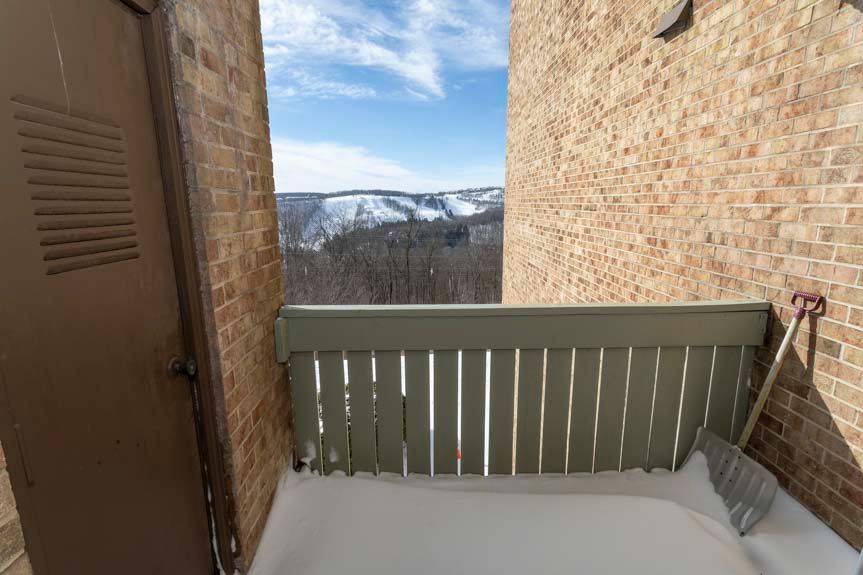 image The small balcony area provides an extension of your living space, overlooking the picturesque snowy hills, perfect for enjoying fresh air.