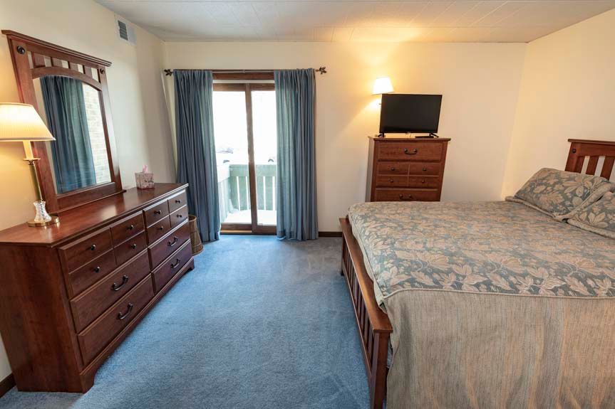 image The serene bedroom is equipped with a cozy bed, stylish furniture, and a balcony door that invites natural light and fresh air.
