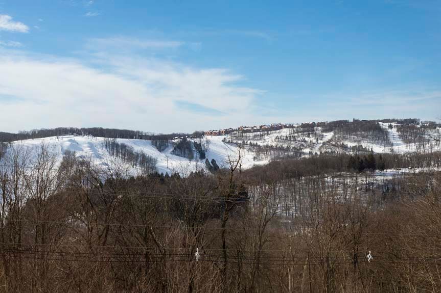 image This stunning view of rolling snowy hills under a bright blue sky showcases the picturesque landscape, ideal for winter sports enthusiasts.