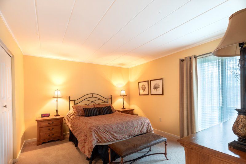image The spacious bedroom offers a relaxing ambiance, highlighted by soft lighting and comfortable furnishings for a restful retreat.